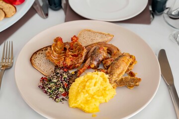 Traditional rustic Brazilian food, guinea fowl, Numida meleagris, with polenta, artisanal bread,...