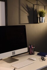 Fototapeta premium Stylish workplace with desk, computer and stationery at home office. Interior design