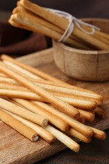 Delicious grissini sticks on wooden table, closeup