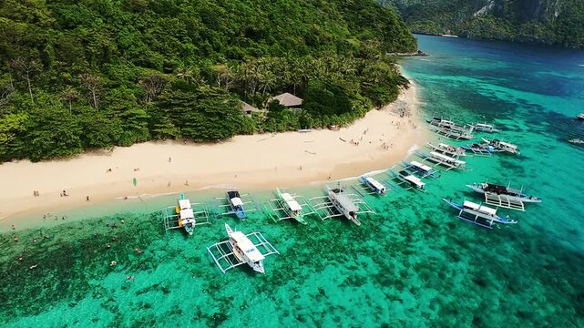 Aerial view of boats anchored along the pristine beach in El Nido, Palawan, Philippines Tropical beach with outrigger boats and crystal water in El Nido, Palawan, Philippines