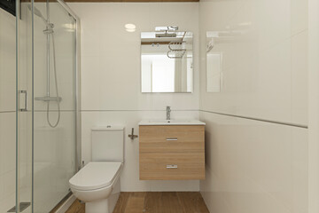 Small modern bathroom with a light wood wall-mounted vanity unit and drawers, optimizing space...