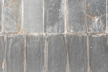 Slate wall in overlapping layers, with metallic reflections
