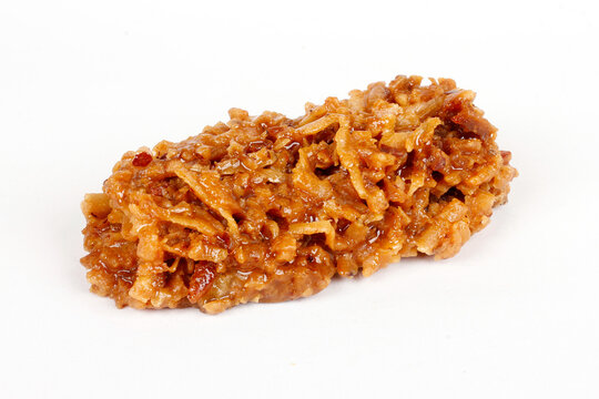 Brazilian brown cocada, coconut candy, a traditional homemade treat very common in Brazil. Isolated on a white background