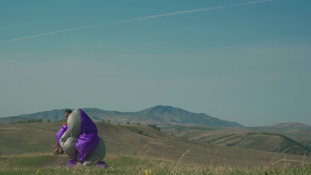Skydiver after landing in wilderness area. Cross country pilot enjoying extreme sports looking for adrenaline, risk, challenges.