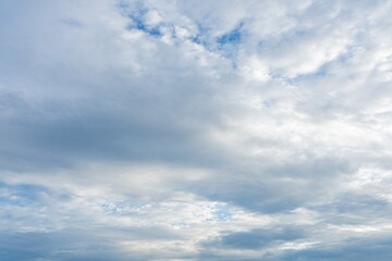 Fototapeta premium Cloudy sky with a mix of white and gray cumulus clouds A daytime view showing varied cloud formations