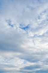 Fototapeta premium Cloudy sky with varying cloud formations and patches of blue High resolution image of a natural sky scene