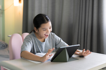 asian child study online class to smile learning on computer tablet or kid girl student fun laugh studying by pad or young woman people happy learn from home school by video call technology education