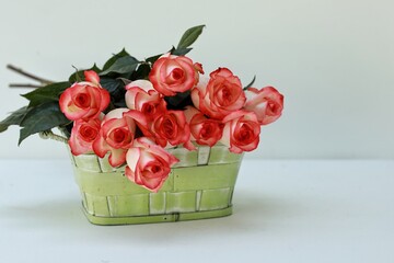 Rose Jumilia, bouquet of roses, pink rose flowers on the table, in a basket, free space