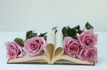 Rose , bouquet of roses, pink rose flowers on the table, free space, book, heart