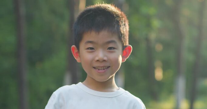Chinese children smiling in the park.