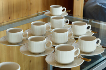 An Elegant Arrangement of White Coffee Cups Beautifully Displayed on Matching Saucers