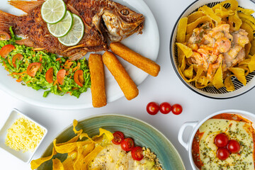 Top view flat lay of a Colombian food feast, a large spread of traditional and modern dishes...