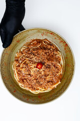 Gourmet Spaghetti Bolognese with a rich meat sauce (ragu) and Parmesan cheese, a classic Italian pasta dish served for dinner as a main course in a rustic bowl, isolated on a white background.
