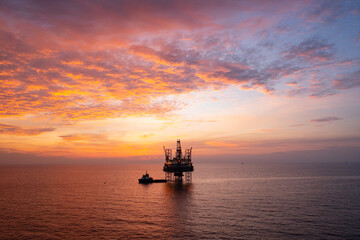 Areal view of offshore jack up rig and offshore platform during sunset for oil and gas exploration...
