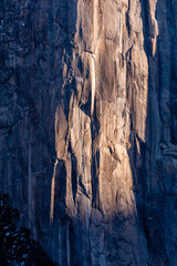 The first rays of the morning sun reflect off the rocks of the Sierra mountains in Yosemite national park, on a snow-covered new years day.