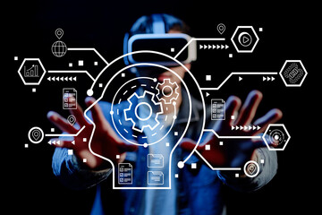 Young man in virtual reality headset engaging with digital interface featuring gears, data graphics, and technology elements, showcasing innovation and interaction