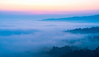 Dreamy pastel sunrise over misty mountain valleys creating a serene and tranquil landscape view