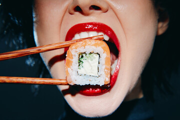 Close-up of a woman enthusiastically eating sushi with chopsticks, showcasing vibrant colors and expressive emotions.