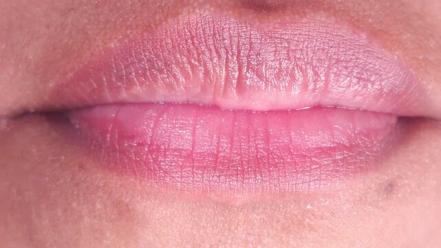Close up Macro of Indian teenage girl lips doing various types of expressions. lift, Frown, grimace, moue, scowl, pout, Kiss, smooch, smack, peck, graze, caress, skim