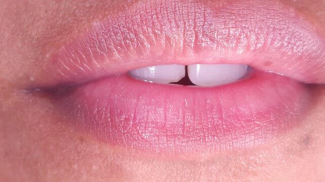 Close up Macro of Indian teenage girl lips doing various types of expressions. lift, Frown, grimace, moue, scowl, pout, Kiss, smooch, smack, peck, graze, caress, skim