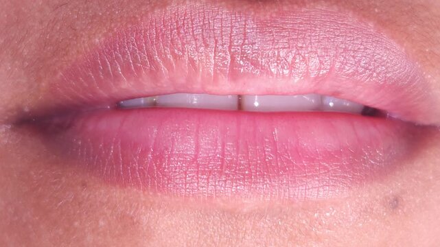 Close up Macro of Indian teenage girl lips doing various types of expressions. lift, Frown, grimace, moue, scowl, pout, Kiss, smooch, smack, peck, graze, caress, skim