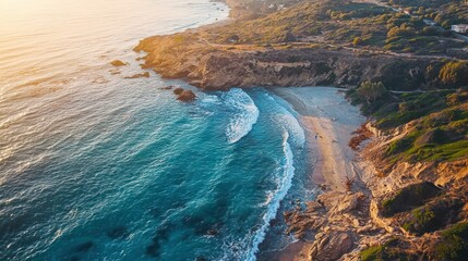 A picturesque coastal scene with a rocky shoreline and turquoise waters at sunset.