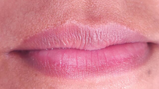 Close up Macro of Indian teenage girl lips doing various types of expressions. lift, Frown, grimace, moue, scowl, pout, Kiss, smooch, smack, peck, graze, caress, skim