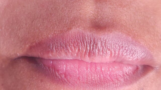 Close up Macro of Indian teenage girl lips doing various types of expressions. lift, Frown, grimace, moue, scowl, pout, Kiss, smooch, smack, peck, graze, caress, skim