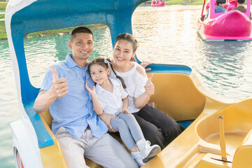 Thai families take pictures on a floating boat for holiday activities.