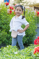 The girl is posing, standing, taking pictures with nature in the evening.