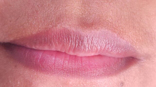 Close up Macro of Indian teenage girl lips doing various types of expressions. lift, Frown, grimace, moue, scowl, pout, Kiss, smooch, smack, peck, graze, caress, skim