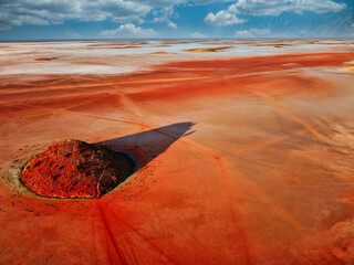 Aerial view of Lake Ballard in Western Australia, showcasing vivid red salt flats, striking land...