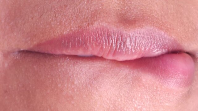 Close up Macro of Indian teenage girl lips doing various types of expressions. lift, Frown, grimace, moue, scowl, pout, Kiss, smooch, smack, peck, graze, caress, skim