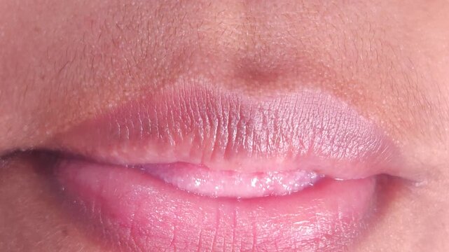 Close up Macro of Indian teenage girl lips doing various types of expressions. lift, Frown, grimace, moue, scowl, pout, Kiss, smooch, smack, peck, graze, caress, skim