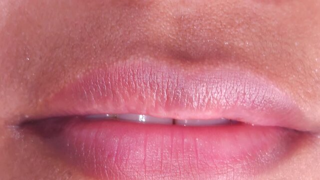 Close up Macro of Indian teenage girl lips doing various types of expressions. lift, Frown, grimace, moue, scowl, pout, Kiss, smooch, smack, peck, graze, caress, skim