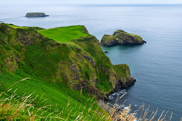 Coastline view of the Carrick-a-Rede Rope Bridge, a suspension bridge connecting the mainland with small Carrickarede island in Ballintoy, County Antrim, Northern Ireland.