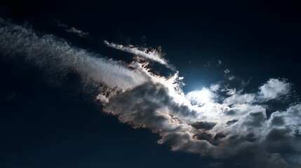 
A dark sky with a large cloud and a sun in the middle. The sun is shining through the clouds, creating a beautiful and serene atmosphere
