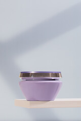 A mock-up of a lilac jar with a nourishing mask for blonde hair. Premium hair care mask.