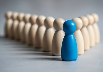 Leadership and Team Blue Wooden Figure Leading a Line of Wooden Figures, Symbolizing Strength, Innovation, and Strategic Vision on a Neutral Background
