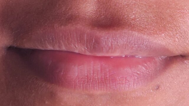 Close up Macro of Indian teenage girl lips doing various types of expressions. lift, Frown, grimace, moue, scowl, pout, Kiss, smooch, smack, peck, graze, caress, skim