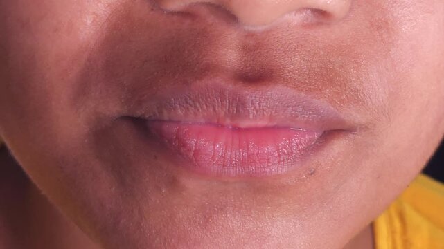 Close up Macro of Indian teenage girl lips doing various types of expressions. lift, Frown, grimace, moue, scowl, pout, Kiss, smooch, smack, peck, graze, caress, skim