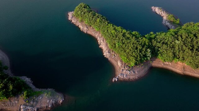 Top-down Aerial Drone Shot of Crocodile Island (Ak-eo-seom) in Chungju Lake, South Korea: Unique Island Shape and Calm Blue Water