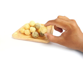 Hands holding typical Indonesian food (Onde-onde) which is served
