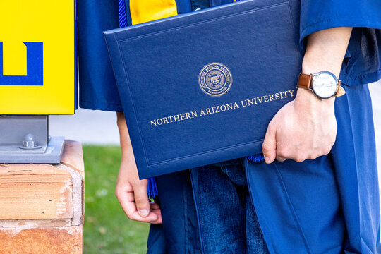 Student holding NAU Bachelor's degree