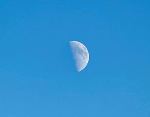 Half moon in a clear blue sky