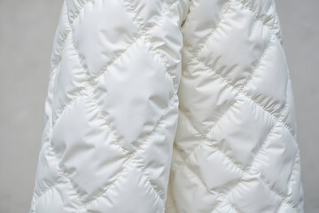 Obraz premium Close-up of Warm White Padded Jacket with Geometric Stitched Pattern