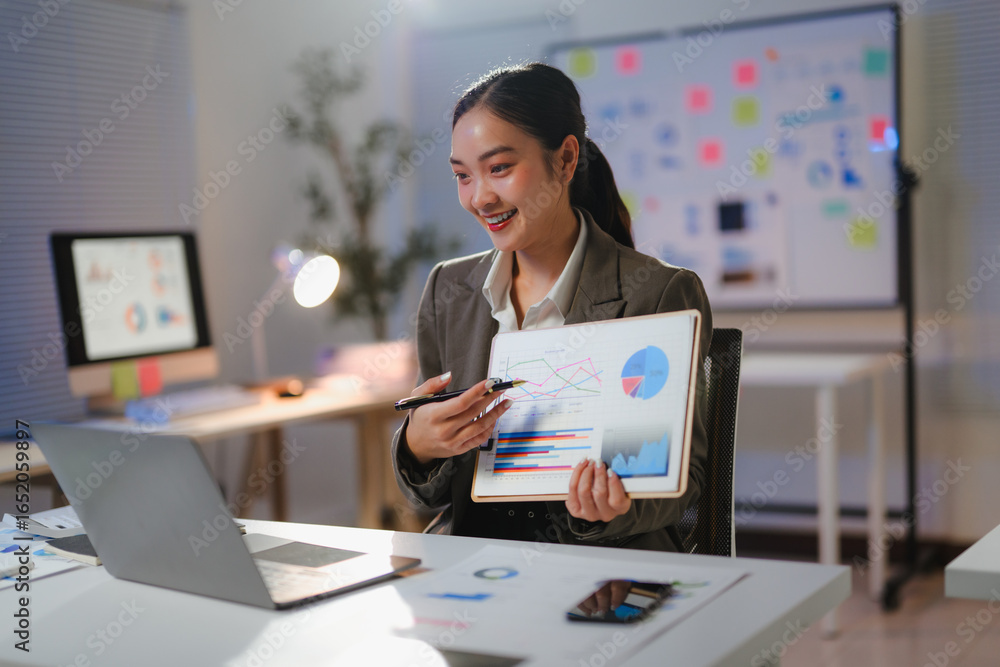 Poster young professional explaining financial data using charts and graphs during an online meeting in her