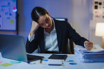 Exhausted professional slumping over paperwork, resting head on hand, overwhelmed by workplace...