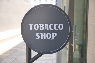 Tobacco shop sign in urban location during daylight