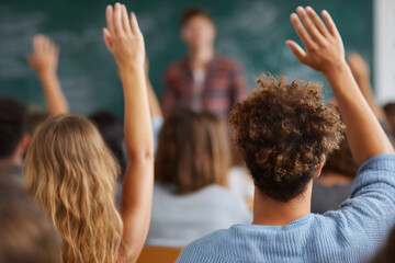 A classroom with students raising their hands